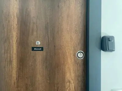 a wooden door with a sign that says march on it at Apartment Welcome in Modriča
