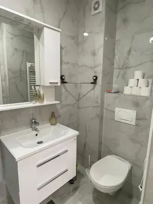 a bathroom with a white sink and a toilet at Apartment Welcome in Modriča
