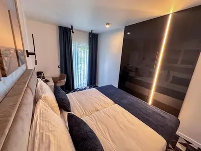 a bedroom with a large bed and a couch at Hotel Modriča in Modriča