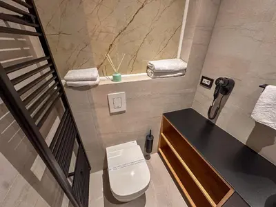 a small bathroom with a toilet and a sink at Hotel Modriča in Modriča