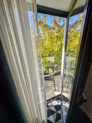 a sliding glass door with a view of a patio at Hotel Modriča in Modriča