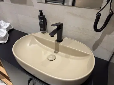 a white bathroom sink with a blow dryer on it at Hotel Modriča in Modriča