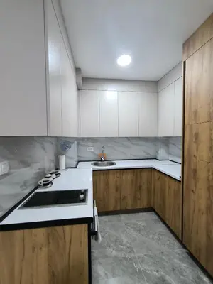 a kitchen with white cabinets and a sink at Apartman Prijedor in Prijedor