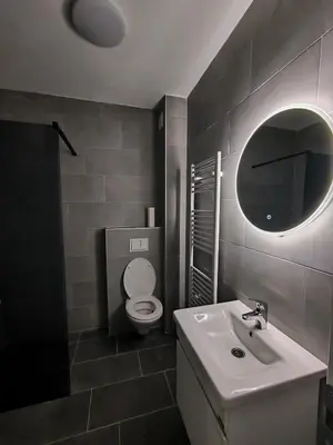 a bathroom with a sink and a toilet and a mirror at Apartman Prijedor in Prijedor