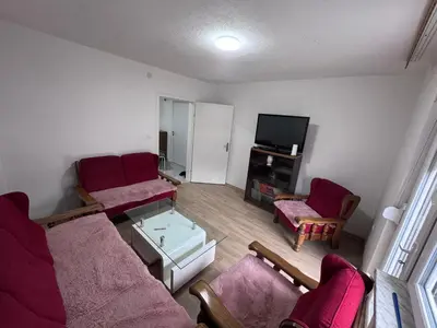 a living room with two couches and a tv at Sweet Home in Tuzla