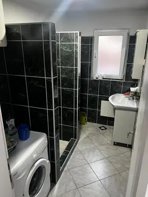 a bathroom with a shower and a toilet and a sink at Sweet Home in Tuzla
