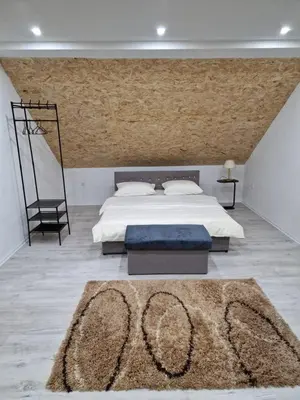 a bedroom with a large bed and a rug at Deya in Kupres