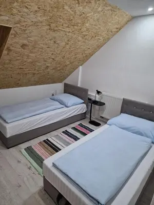 two beds in a room with a ceiling at Deya in Kupres