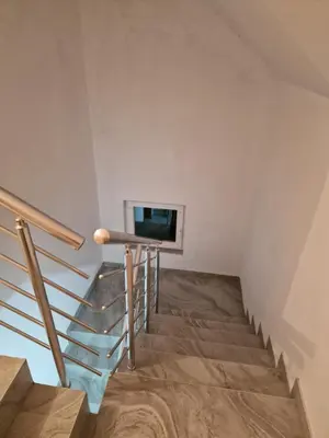 a staircase in a house with a tv on the wall at Deya in Kupres