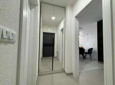 a hallway with a mirror and a dining room at Amare Apartment in Livno