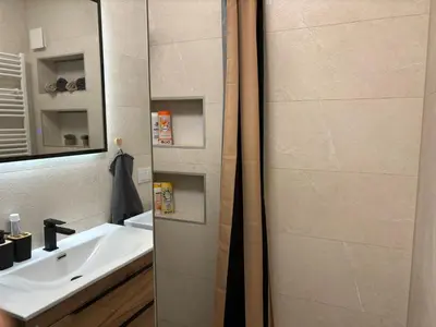 a bathroom with a sink and a mirror at Amare Apartment in Livno