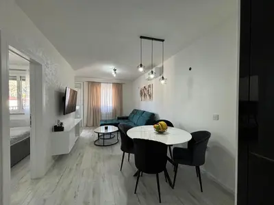 a living room with a table and a couch at Amare Apartment in Livno