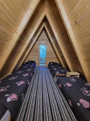 a room with two beds in a attic at Bungalovi Krupa in Banja Luka
