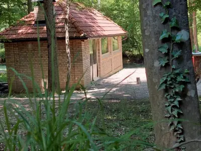 a small brick building with a door in a yard at Bungalovi Krupa in Banja Luka