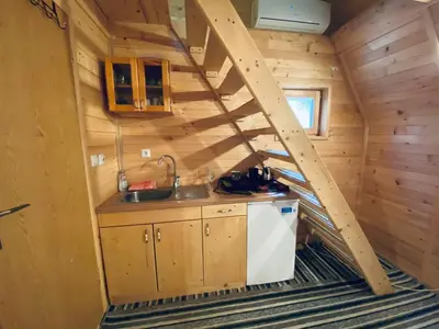 a kitchen in a tiny house with a staircase at Bungalovi Krupa in Banja Luka
