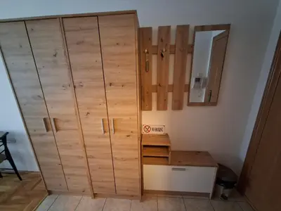 a large wooden cabinet in a corner of a room at Studio Maja in Banja Luka