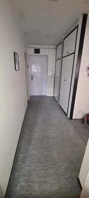 an empty room with white walls and a gray carpet at All app in Travnik