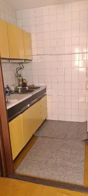 a kitchen with yellow cabinets and a sink at All app in Travnik