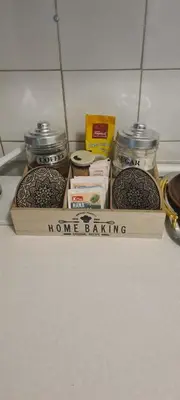 a wooden box with jars of food on a shelf at All app in Travnik