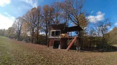 a tree house sitting in the middle of a field at Red Brick Guest House