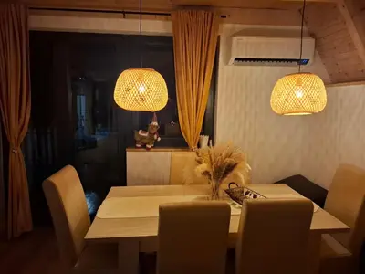 a dining room table with chairs and two lights at Red Brick Guest House