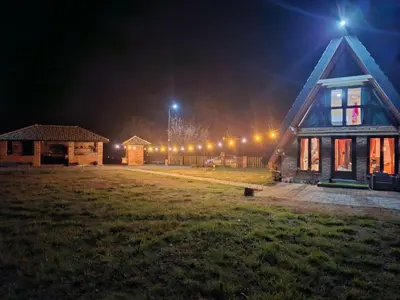 a house at night with lights on it at Red Brick Guest House