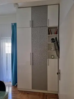 a white cabinet with a glass door in a room at Apartman Nina in Banja Luka
