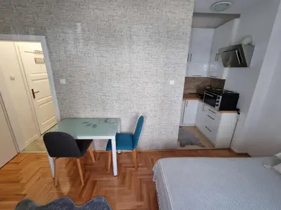 a small room with a table and two chairs at Apartman Nina in Banja Luka