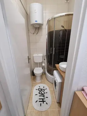 a small bathroom with a toilet and a sink at Apartman Nina in Banja Luka