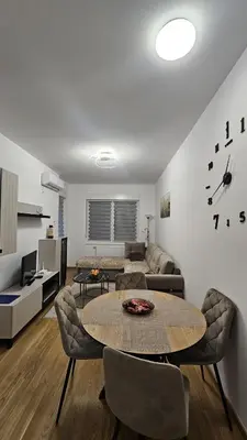 a living room with a table and a couch at Dana in Banja Luka