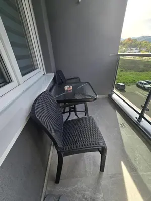a table and chairs in a room with a window at Dana in Banja Luka