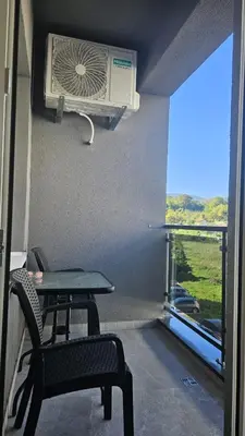 a room with a table and a fan and a window at Dana in Banja Luka