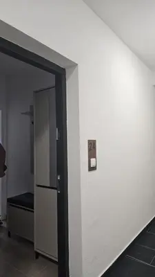 an open door to a room with a refrigerator at Dana in Banja Luka