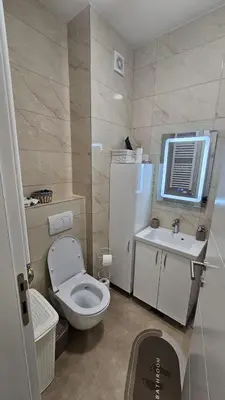 a small bathroom with a toilet and a sink at Dana in Banja Luka