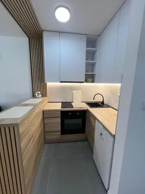 a small kitchen with a sink and a stove at Lux Iva apartman in Doboj