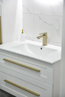 a white bathroom with a sink and a mirror at Lux Iva apartman in Doboj