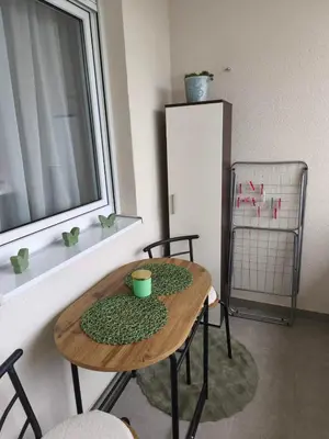 a kitchen with a table and chairs and a window at Diva apartman, Doboj in Doboj