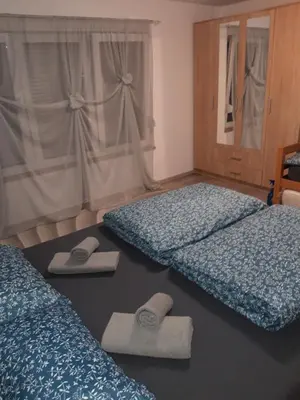 a bedroom with two beds and slippers on the floor at Odmor za umorne in Banja Luka