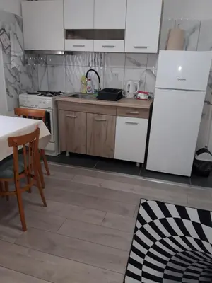 a kitchen with a white refrigerator and a table at Odmor za umorne in Banja Luka