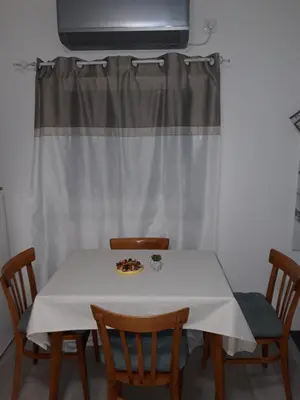 a white table with chairs and a plate of food on it at Odmor za umorne in Banja Luka