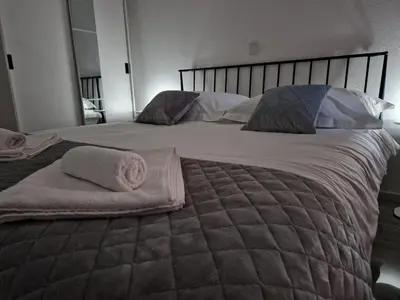 a large bed with two pillows on top of it at Apartman Bistrica in Livno
