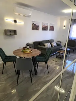a living room with a table and a couch at Apartman Bistrica in Livno