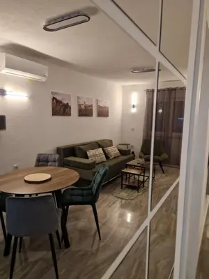 a living room with a couch and a table at Apartman Bistrica in Livno