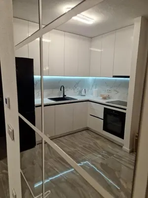 a kitchen with white cabinets and a sink at Apartman Bistrica in Livno