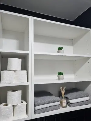 a white shelf with towels and towels at Apartman Novak in Banja Luka
