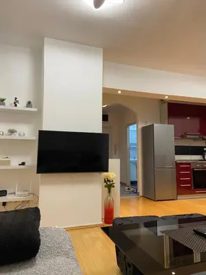 a living room with a flat screen tv on a wall at Apartman Sara in Banja Luka