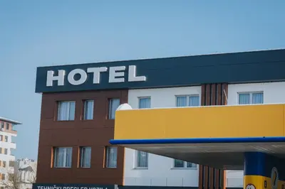 a hotel with a sign on top of it at Hotel Brcko Gas Doboj in Doboj