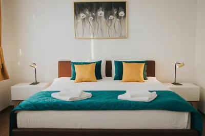 a bedroom with a bed with two towels on it at Hotel Brcko Gas Doboj in Doboj
