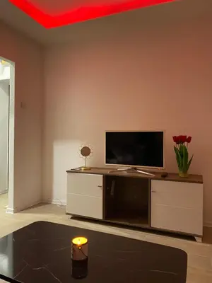 a living room with a flat screen tv on a entertainment center at Elyisian Home in Zenica