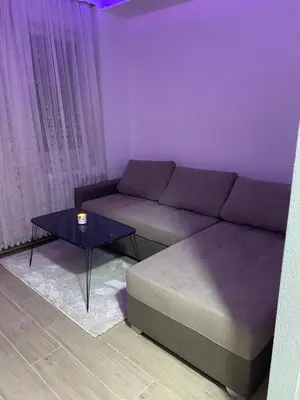 a living room with a couch and a table at Elyisian Home in Zenica